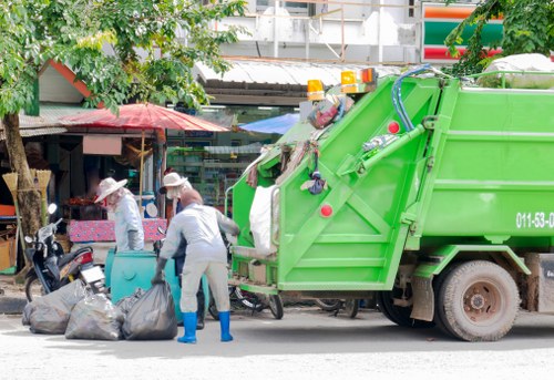 Operatives wearing protective equipment carrying out waste removal